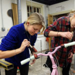 Students painting and decorating bikes in the sculpture studio, Wednesday Dec. 2, 2015. (Photo by Norm Shafer).