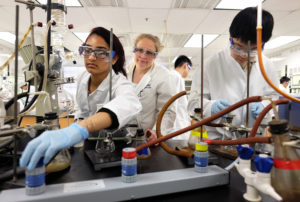 Kelli Slunt keeps a close eye on two up-and-coming chemists inside a state-of-the-art Jepson Science Center lab. om across the country competed to represent the U.S. in July's 48th International Chemistry Olympiad. (Photo by Norm Shafer).