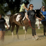 UMW students participate in the therapeutic horseback riding program at Hazelwild Farm. Photo by Reza A. Marvashti.