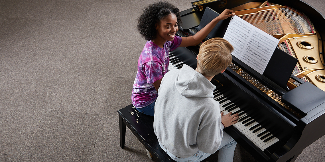 Two students at a piano