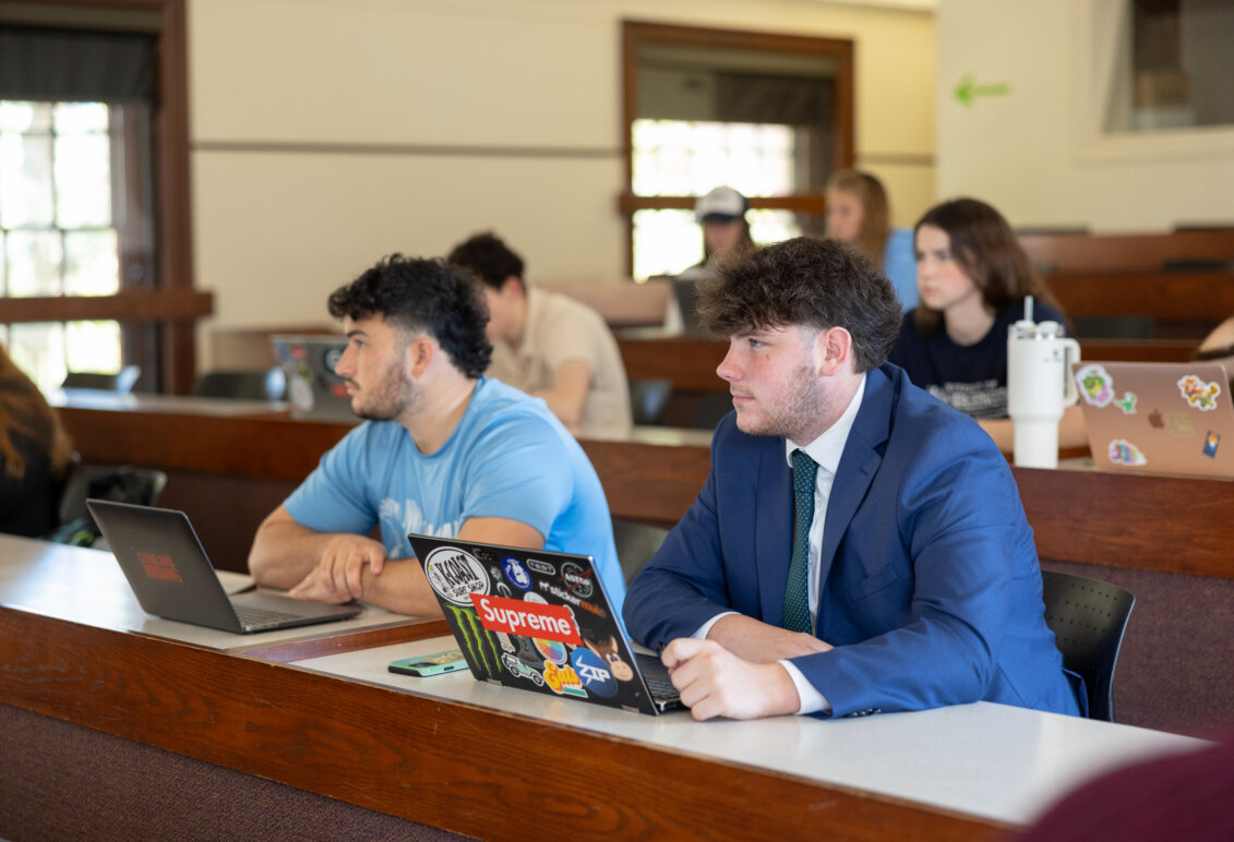 Two students looking off in a classroom setting.