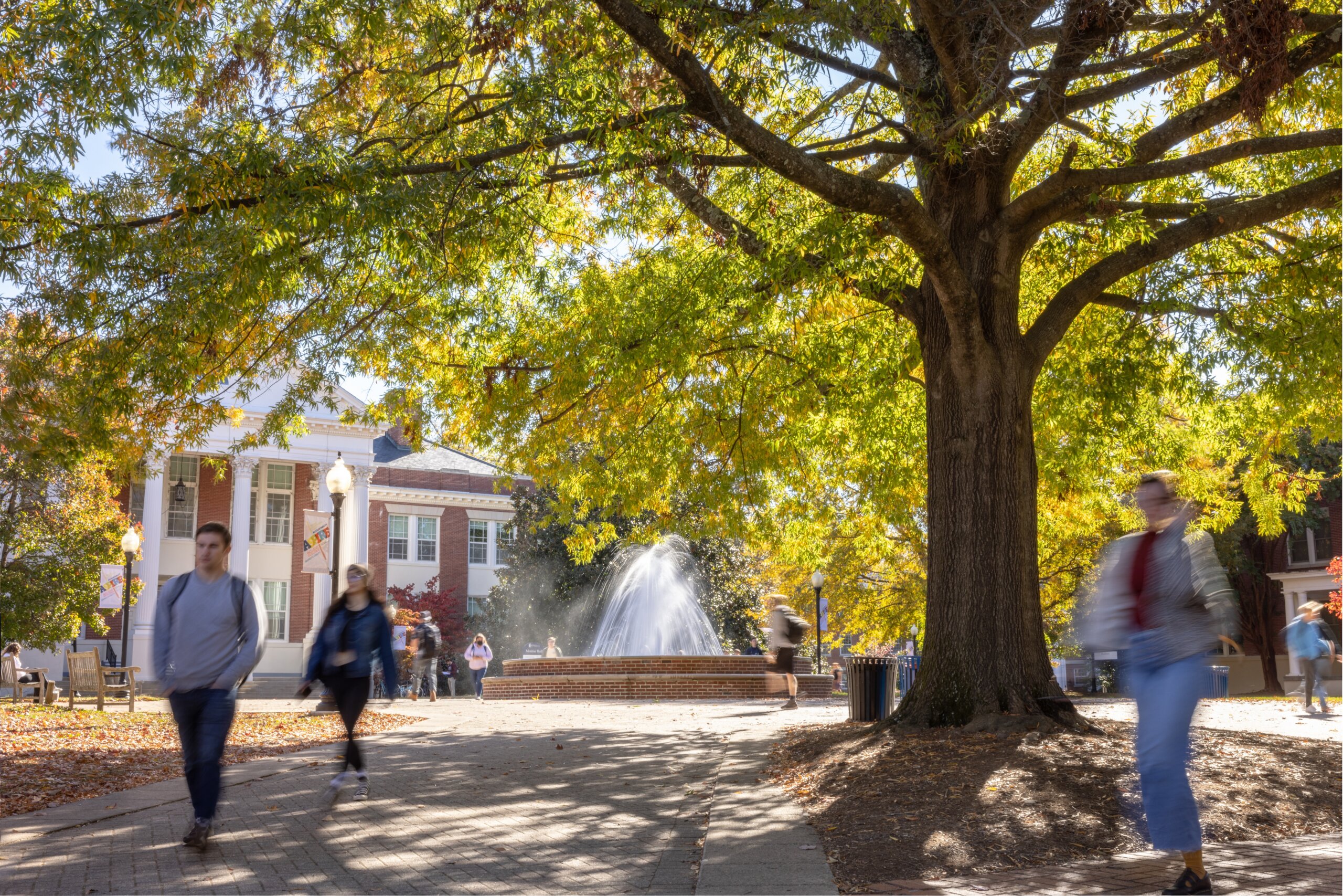 Students walk through Paliemeri Plaza on a fall day.