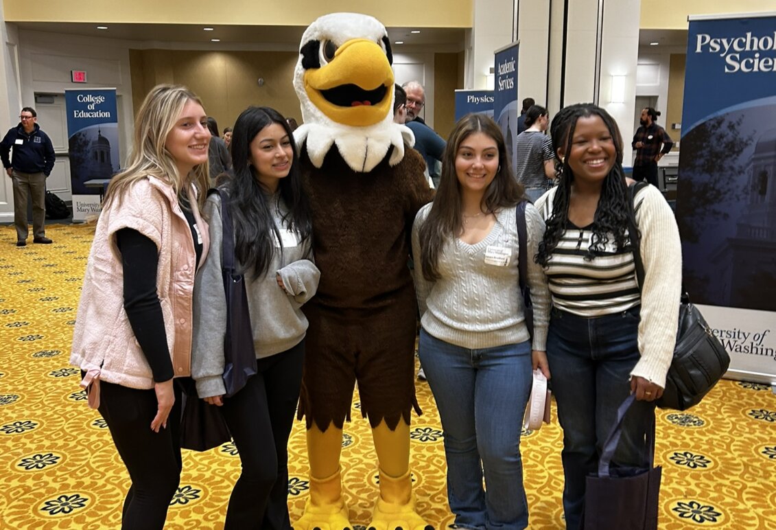 Four students with the mascot