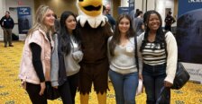 Four students with the mascot