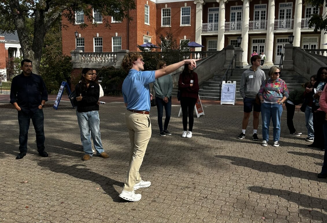 A tour guide takes families around campus