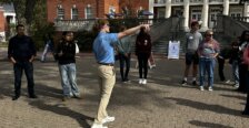 A tour guide takes families around campus
