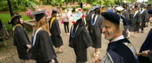 Photo of President Paino with students at Commencement