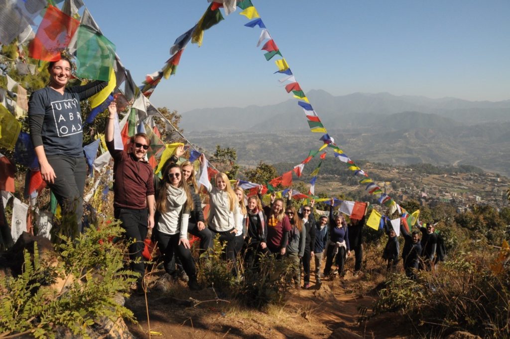 Students studying abroad standing on a mountain trail.