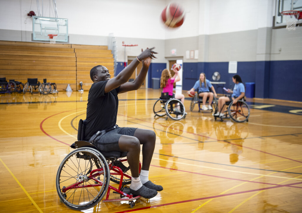 Man in a wheelchair playing basketball