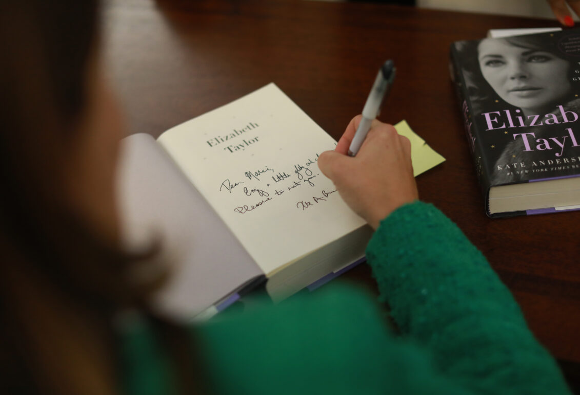 Author signing her book titled "Elizabeth Taylor".