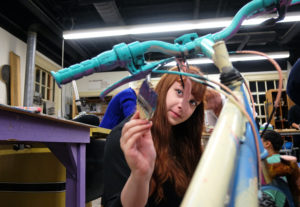 Students painting and decorating bikes in the sculpture studio, Wednesday Dec. 2, 2015. (Photo by Norm Shafer).