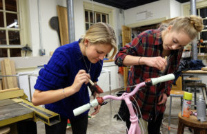 Students painting and decorating bikes in the sculpture studio, Wednesday Dec. 2, 2015. (Photo by Norm Shafer).