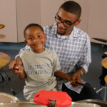 UMW junior Ben Henderson works with young children at the Family Life Center in Fredericksburg. Henderson, who is double majoring in religion and sociology, is set on going to seminary school and focused on building better communities. Photo by Norm Shafer.