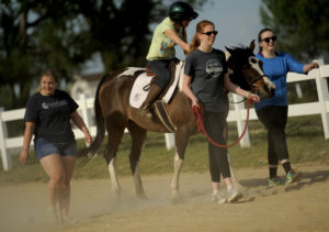 UMW students participate in the therapeutic horseback riding program at Hazelwild Farm. Photo by Reza A. Marvashti.