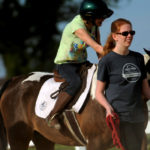 UMW students participate in the therapeutic horseback riding program at Hazelwild Farm. Photo by Reza A. Marvashti.