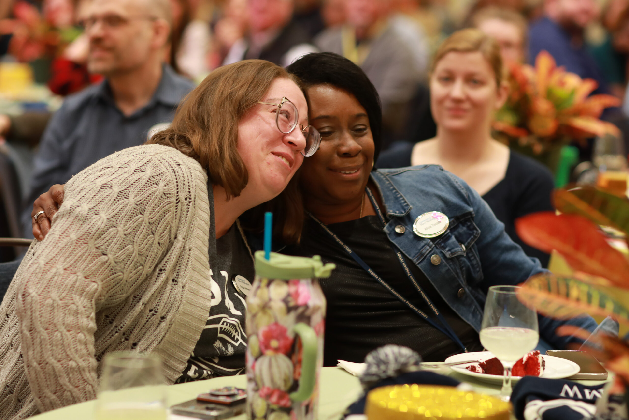 Faculty hugging at the Staff/Faculty Thanksgiving lunch