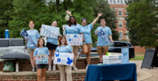 Group of students holding welcome signs during move-in day