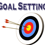 words 'goal setting' with a target and three arrows hitting the center