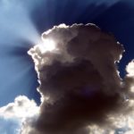 rays of light peeking out from behind a cloud.