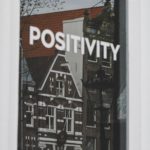photo of a building and the word positivity written across the image