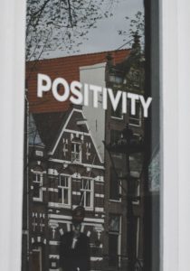 photo of a building and the word positivity written across the image