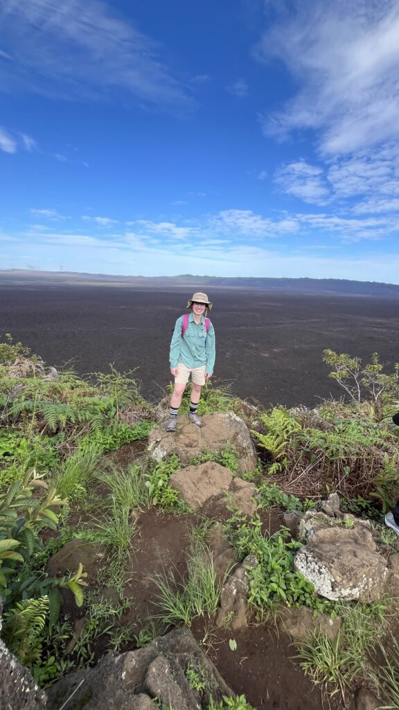 Student stands on the rim of Sierra Negra, overlooking a volcanic crater.