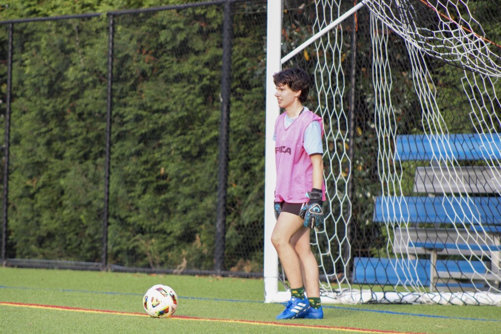 Student on the UMW Club Soccer team standing in goal with a ball on the ground. 
