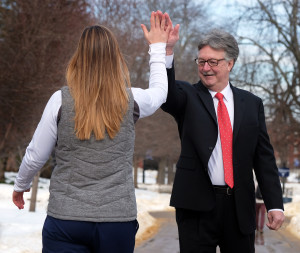 President Hurley high fiving a student
