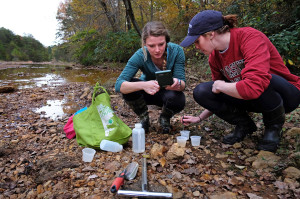UMW Senior Maura Slocum (left) collecting soil, water and plant samples along Contrary Creek in Louisa County with a fellow student.