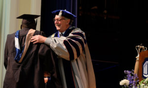 UMW President Richard V. Hurley congratulates a student during the school's graduate school graduation, May 6, 2015. (Photo by Norm Shafer).