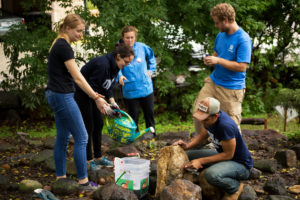 Students wash a natural sundial at Downtown Greens.