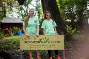 Lauren Mosesso (left) and senior Mona Osmer pose in front of Downtown Greens.