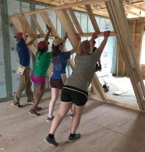 Students raising a wall.