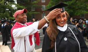 UMW Dean of Students helps Mollie Welty adjust her mortarboard. Photo Norm Shafer.