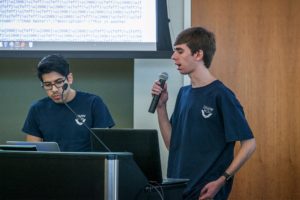 Diego Bustamante and Collin Mistr of Team Devils present at HackU 5. The team won the Best Solution to a Challenge category and took home tickets to the Revolution Conference in June.
