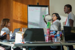 Mikaela Goldrich, Hunter Renard, Anum Qureshi, and Josh Mwandu from Team Goats work through a challenge at HackU 5. The team won the Best Open Source Project category and took home Amazon Dots.