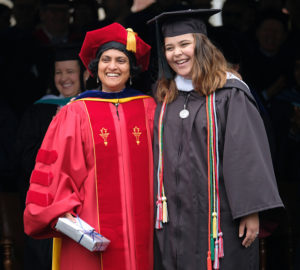 Laura Gilchrist presents the Mary W. Pinschmidt Award to Surupa Gupta, associate professor of political science and international affairs. The winner is selected by the graduating class as the faculty member “they will most likely remember as the one who had the greatest impact on their lives.” Photo by Norm Shafer.