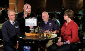 From left, UMW President Troy D. Paino, Enterprise Screen Video Communications Executive Director Jamie Smith, Adventure Brewing Brand Ambassador Wade Bedell, and Professor of Chemistry Janet Asper take part in a beer tasting at the Underground during filming of "The New Guy" video series. The efforts resulted in UMW's new craft beer, Devil's Goat. Photo by Norm Shafer.