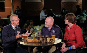 From left, UMW President Troy D. Paino, Adventure Brewing Brand Ambassador Wade Bedell, and Professor of Chemistry Janet Asper take part in a beer tasting during filming of "The New Guy" at the Underground. The efforts contributed to UMW's new craft beer, Devil's Goat. Photo by Norm Shafer.