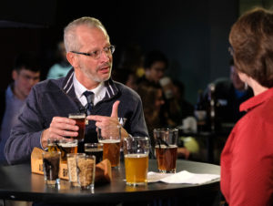 UMW President Troy D. Paino talks with Professor of Chemistry Janet Asper during a beer tasting on the set of "The New Guy." Photo by Norm Shafer.