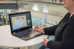 Kelsey Keplinger, who recently defended her capstone project for UMW's master's in geospatial analysis degree, uses satellite pixels to match fires with terrorist events. Photo by Jarred Cannon.