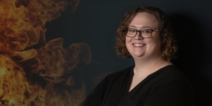 Kelsey Keplinger, who recently defended her capstone project for UMW's master's in geospatial analysis degree, uses satellite pixels to match fires with terrorist events. Photo by Clement Britt.