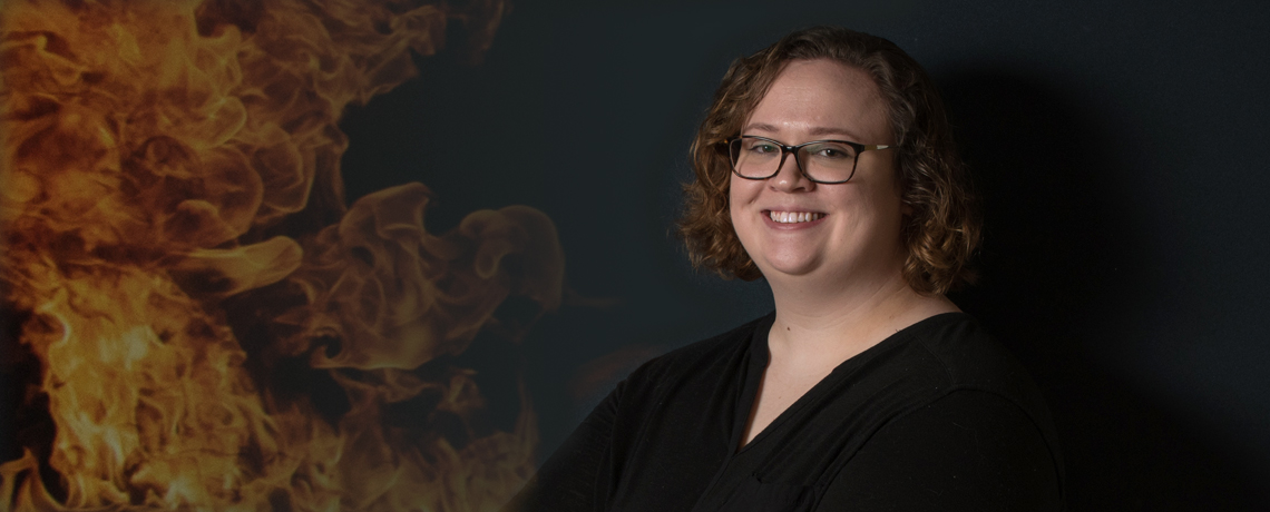 Kelsey Keplinger, who recently defended her capstone project for UMW's master's in geospatial analysis degree, uses satellite pixels to match fires with terrorist events. Photo by Clement Britt.