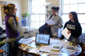 (From left to right) Downtown Greens Executive Director Sarah Perry speaks with UMW juniors Jasmine Pope and Tirzah Rao. Photo by Norm Shafer.