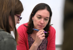 Caitlie Finlayson working with students in her World Geography class.