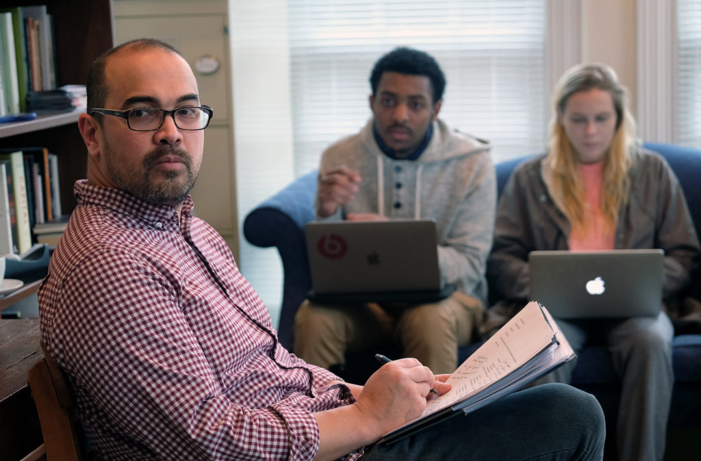 Students meet in Assistant Professor of English, Linguistics and Communications Jon Pineda’s office to discuss coursework.