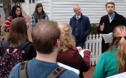 Michael Spencer, top right, talks with historic preservation majors outside the Mary Washington House.