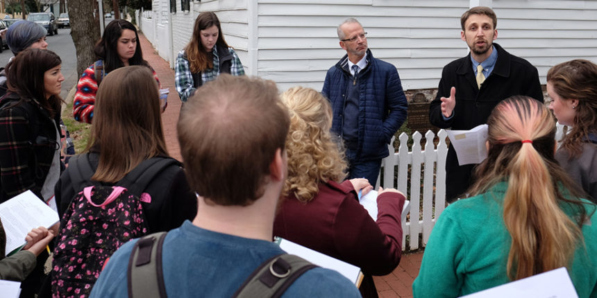 Michael Spencer, top right, talks with historic preservation majors outside the Mary Washington House.
