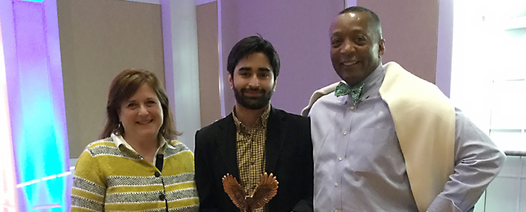Melissa Mann, mother of Grace Mann, a junior student leader and social justice activist who died in 2015, poses with Ahad Shahid '18, winner of the award created in her memory. At right is Associate Vice President for Student Affairs and Dean of Student Life Cedric Rucker, who announced the Grace Mann Launch Award winner during the annual Eagle Awards ceremony Thursday night.