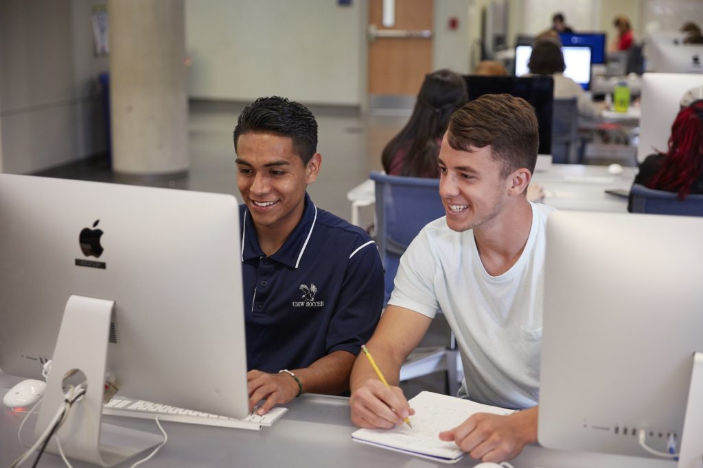 From left: Sophomore Gabriel Soriano and senior Curran Smolinsky, members of the men’s soccer team, study in the Hurley Convergence Center.